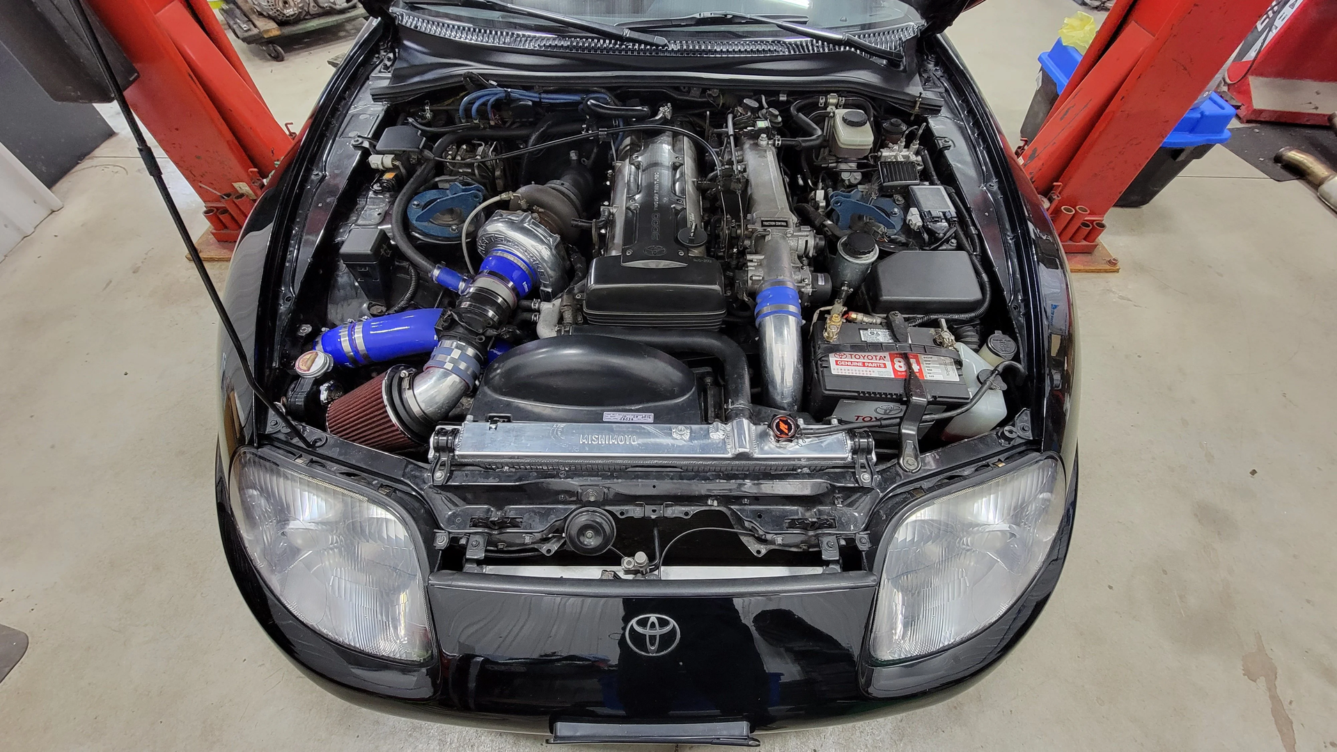 Toyota Supra JZA80 engine bay featuring a 2JZGTE VVTI single-turbo conversion with intercooler piping and high-flow intake — representative of a G40-1150 build setup.